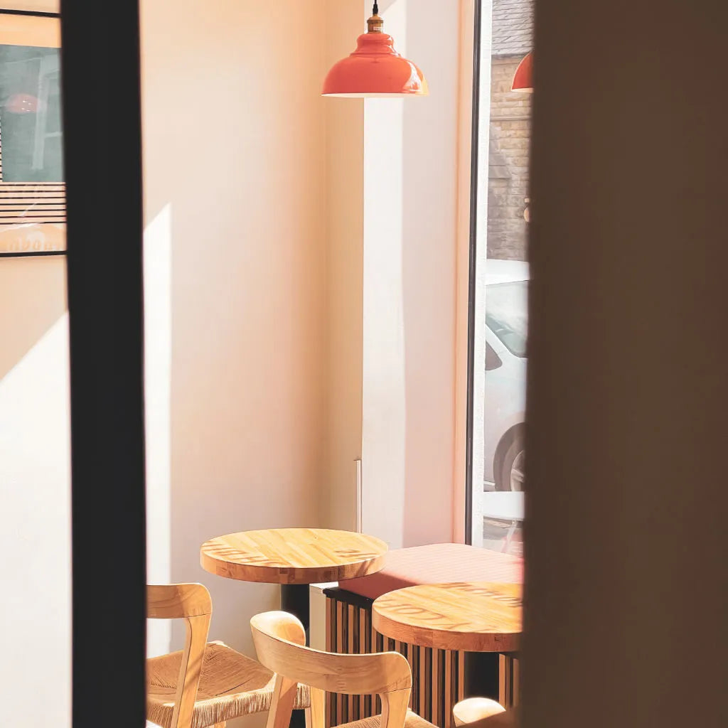 A table and chairs positioned in front of a large window, allowing natural light to fill the space.
